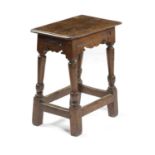 A CHARLES II OAK JOINT STOOL C.1660 the seat with a moulded edge above a bicuspid frieze on turned