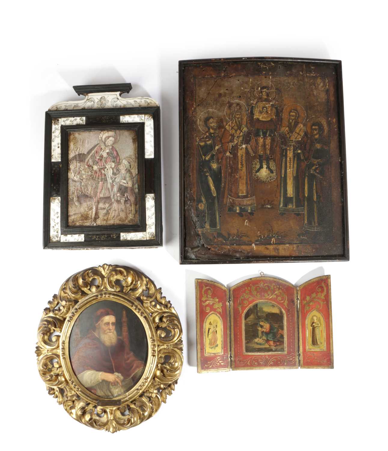 A RUSSIAN ICON egg tempera on panel, depicting four saints around an angel, with remains of