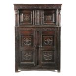 AN OAK COURT CUPBOARD LATE 17TH CENTURY carved with foliate lunettes, cartouches and strapwork