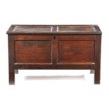 AN OAK AND ELM TWIN PANELLED COFFER 18TH CENTURY the vacant interior originally with a till 61cm