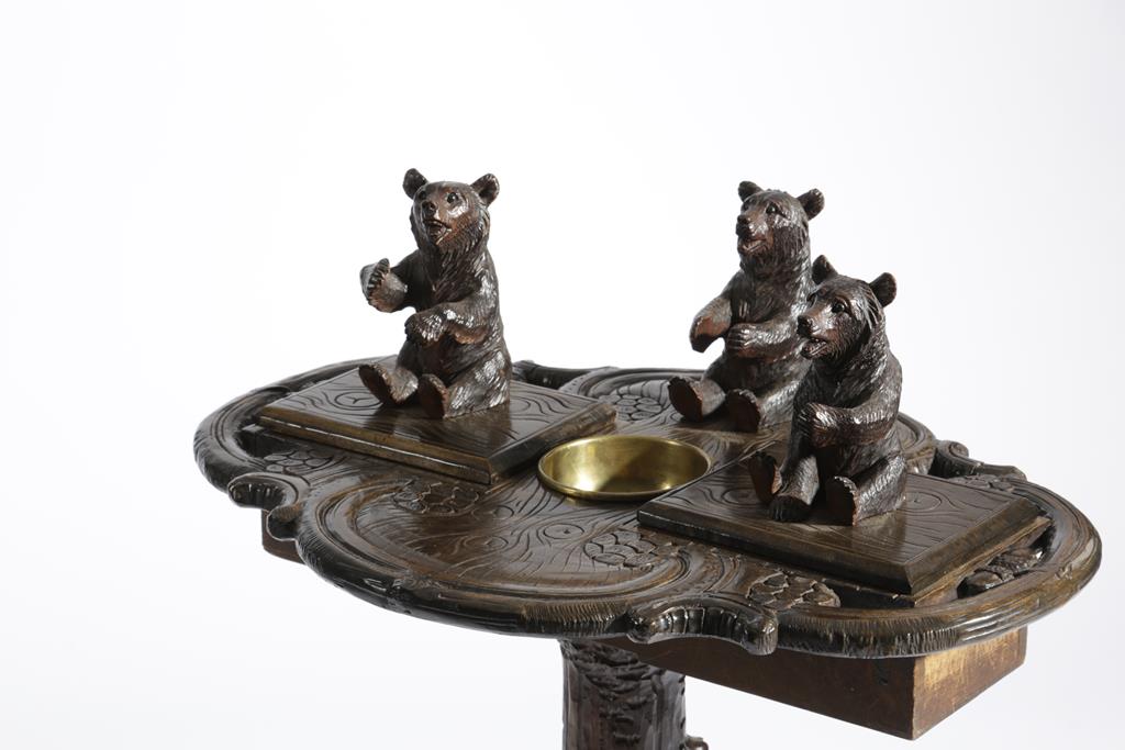 A BLACK FOREST LINDEN WOOD SMOKER'S COMPANION TABLE LATE 19TH CENTURY carved with a standing bear - Image 2 of 3
