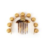 λ A gilt metal and tortoiseshell hair ornament, mid 19th century, designed as a headband set with