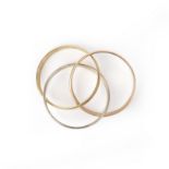 A gold bangle, composed of three interlocking hoops in yellow, rose and white gold respectively,