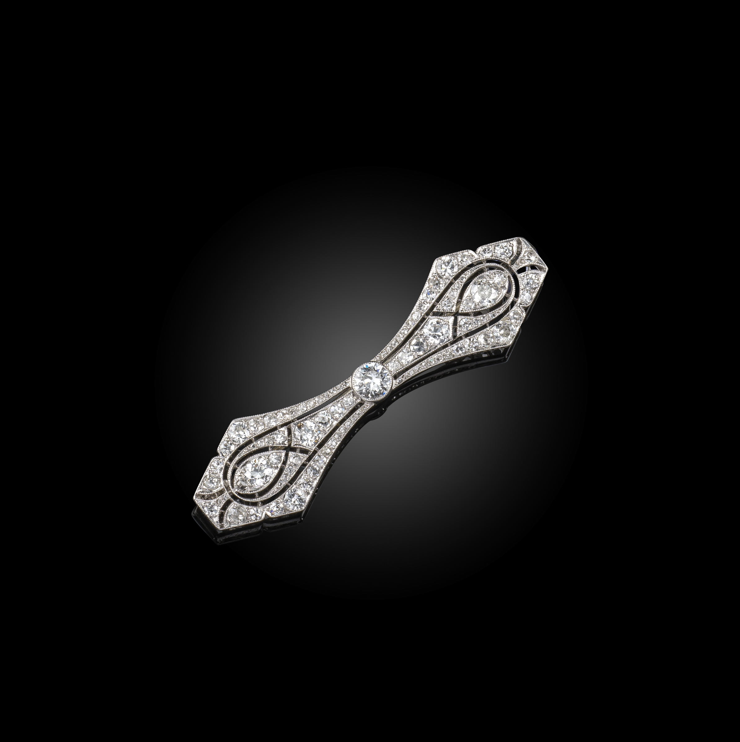 Lacloche Frères, an Art Deco diamond brooch, circa 1920, designed as a stylised openwork bow,