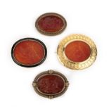 A group of four carnelian intaglio brooches, the brooches each set with a modern intaglio