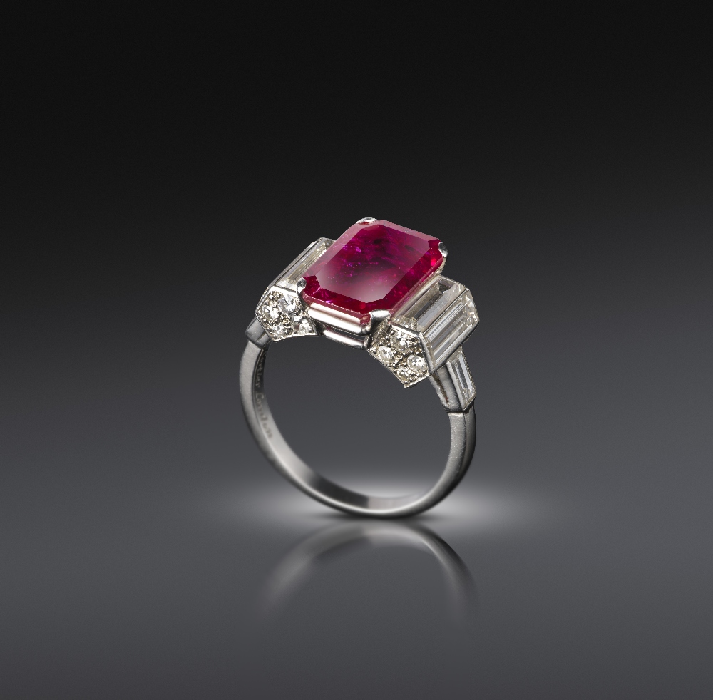 Cartier, an Art Deco ruby and diamond ring, C1935, the emerald-cut ruby measuring 13.04 x 8.10 x 3.