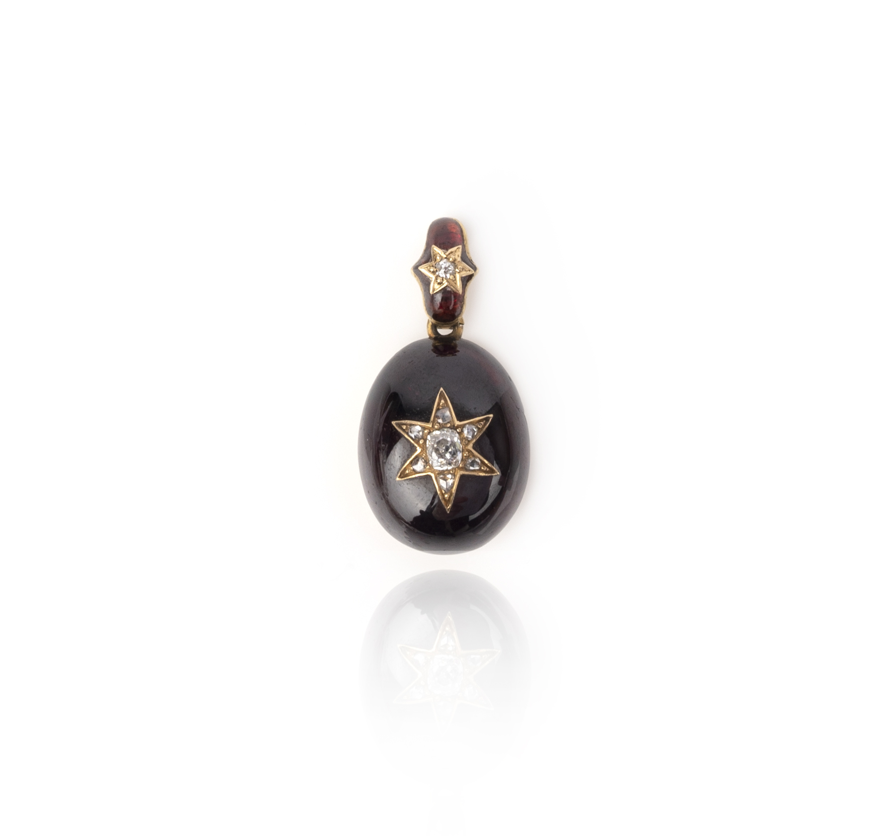 A garnet and diamond mourning pendant, mid 19th century, composed of a cabochon garnet drop, set