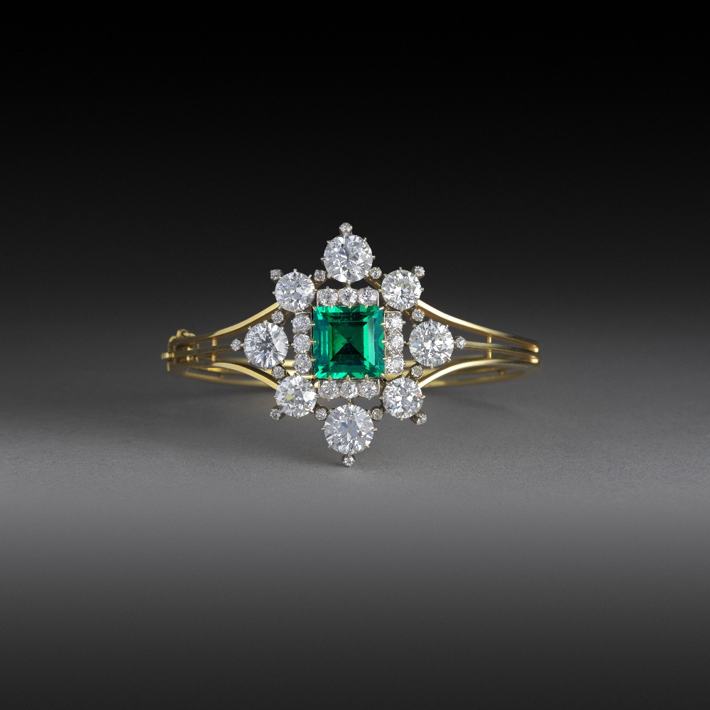 A superb Victorian emerald and diamond bangle, circa 1860, claw-set with a step-cut emerald weighing