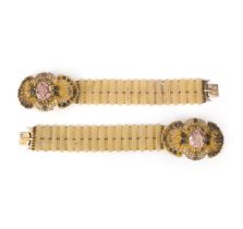 A pair of paste and gilt metal bracelets, 1830s, each centring on an oval pink paste, within a