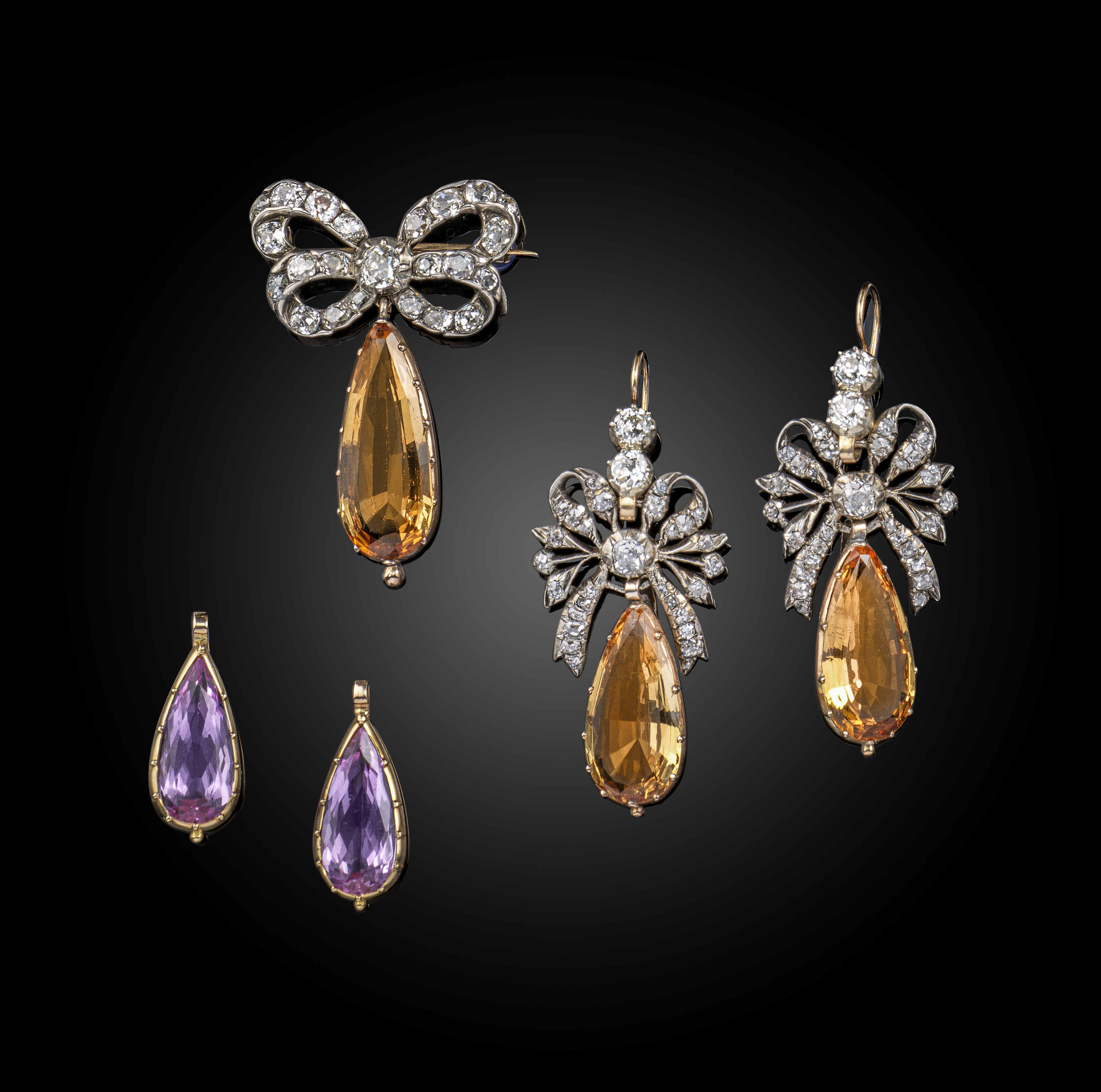 A late 18th century (and later) topaz demi parure, the closed-back silver diamond-set bows suspend