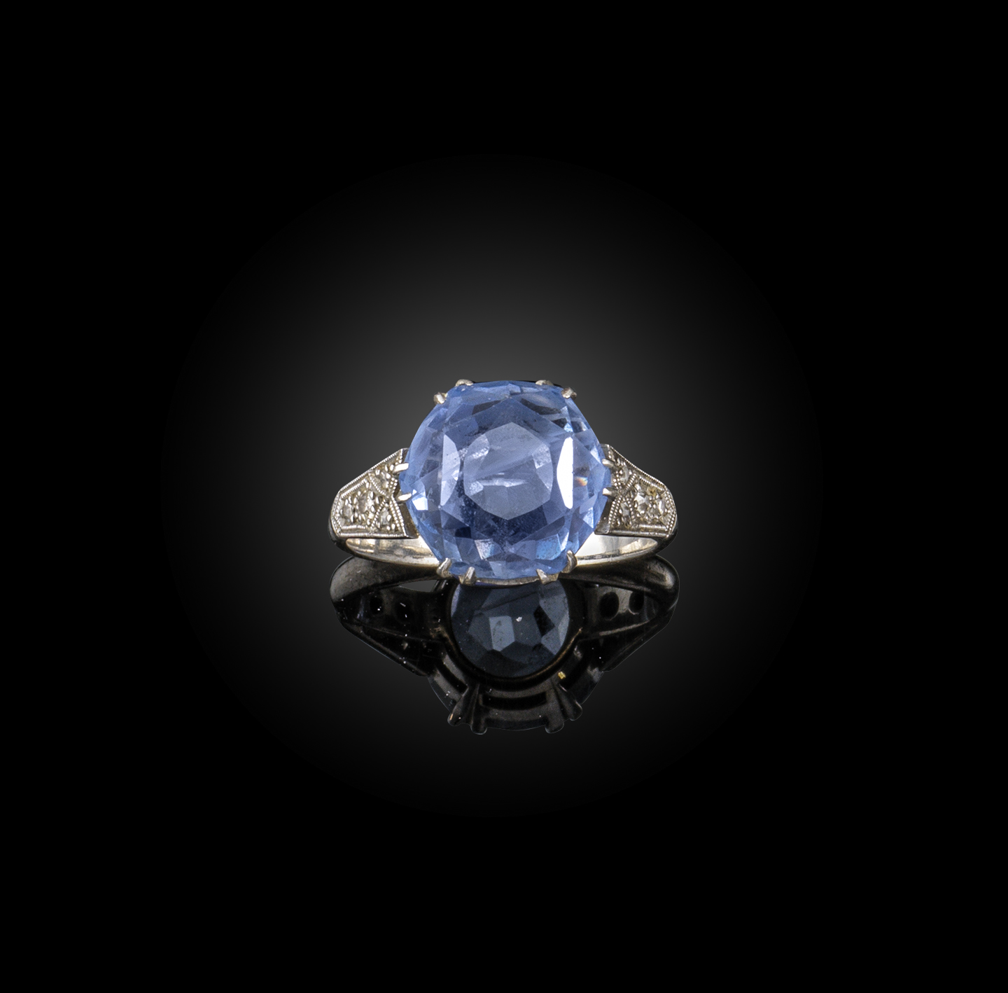 A sapphire solitaire ring, the hexagonal sapphire with rose-cut diamond shoulders in platinum,