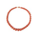 λ A coral bead necklace, composed of graduated coral beads, measuring approximately 7.9-13.8cm, to a