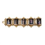 A mid 19th century metal bracelet, set with five rectangular panels depicting typical Swiss dress,