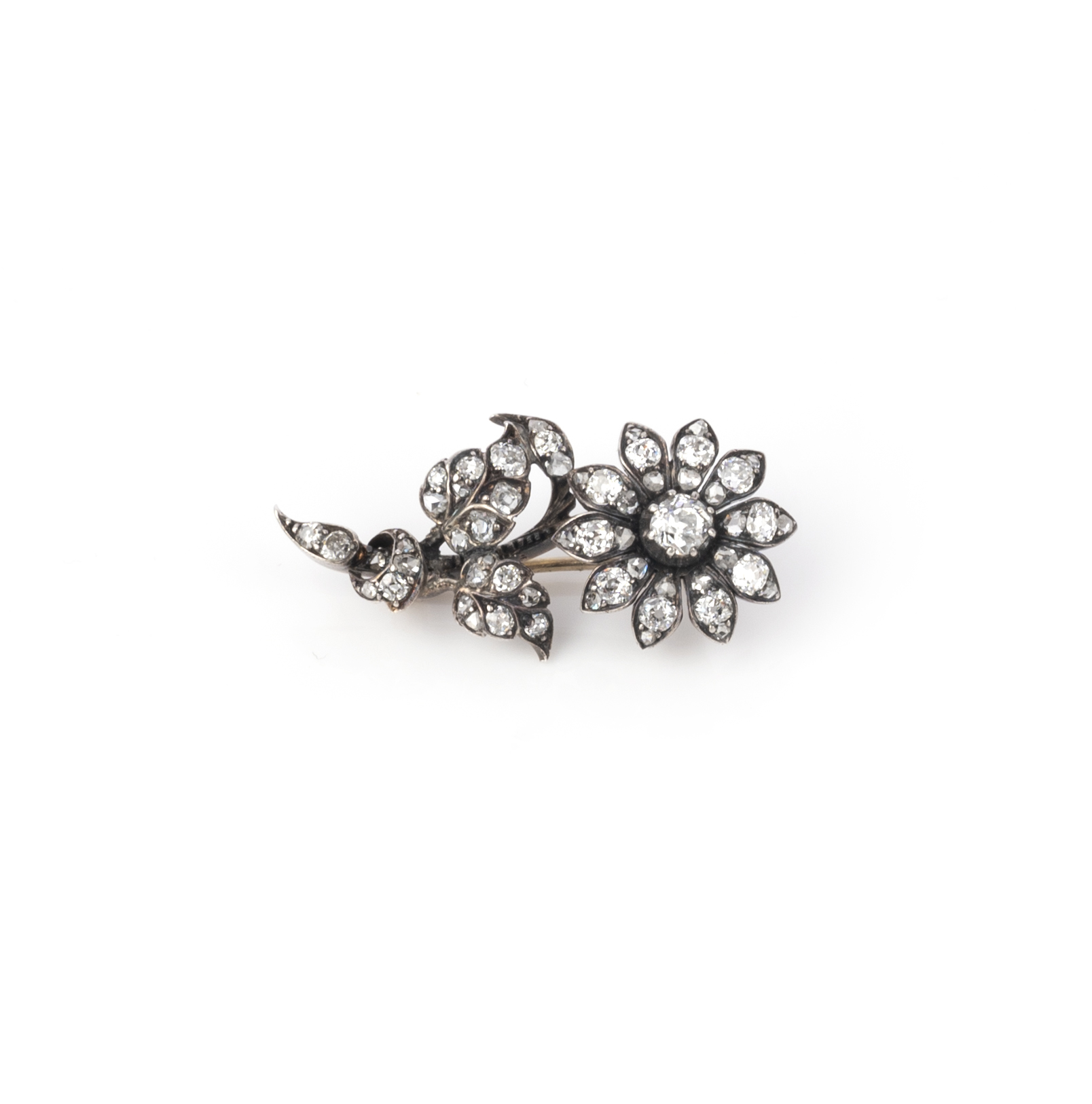 A late 19th century diamond flower brooch, set with graduated old cushion-shaped diamonds in