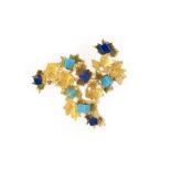 A lapis lazuli and turquoise brooch, 1970s, of abstract textured design in gold, composed of