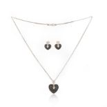 A black diamond demi-parure, comprising: a pendant neckalce and a pair of earrings, each designed as