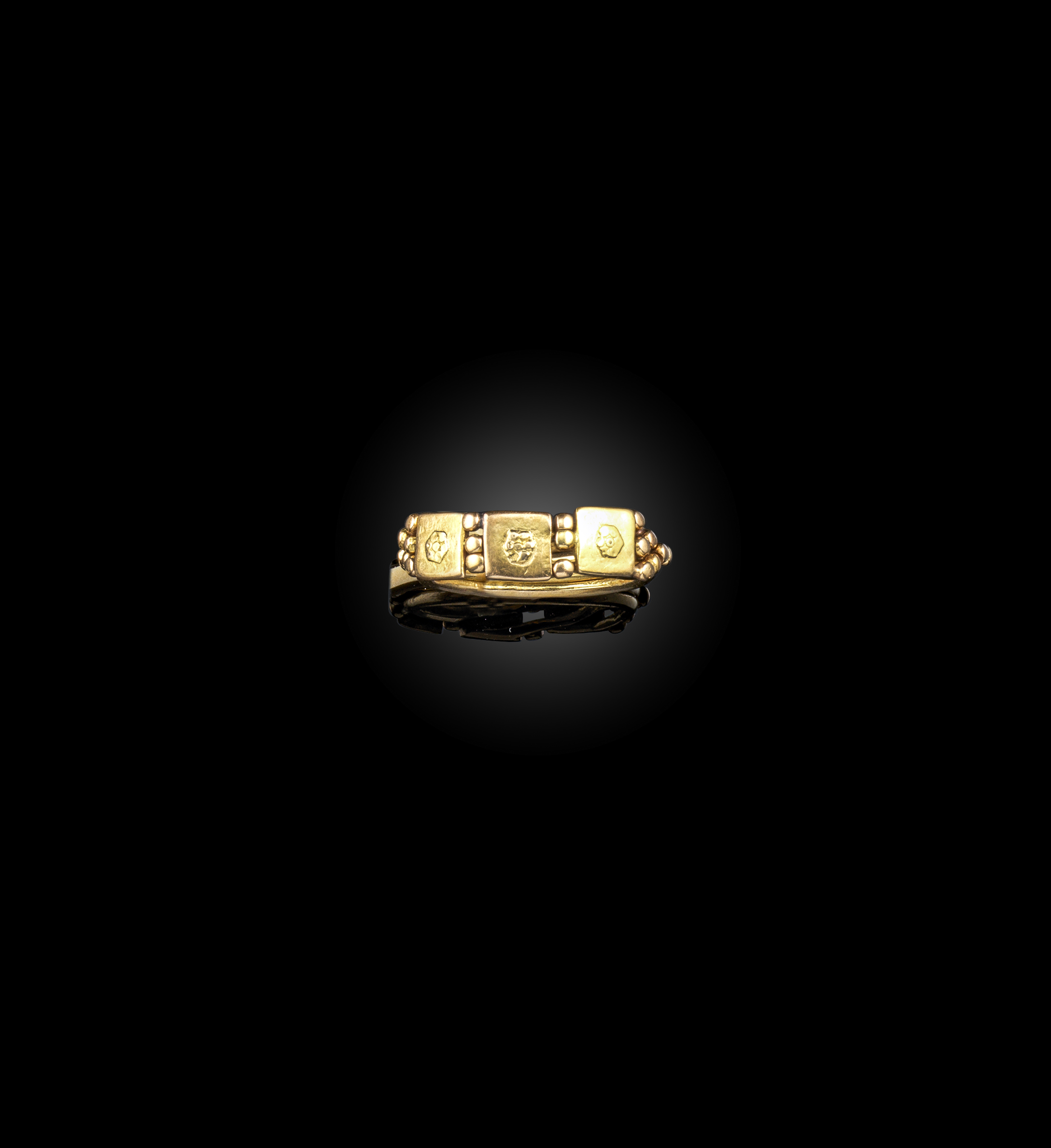 An unusual gold puzzle ring, designed as three gold panels centring on floral motifs, spaced by gold