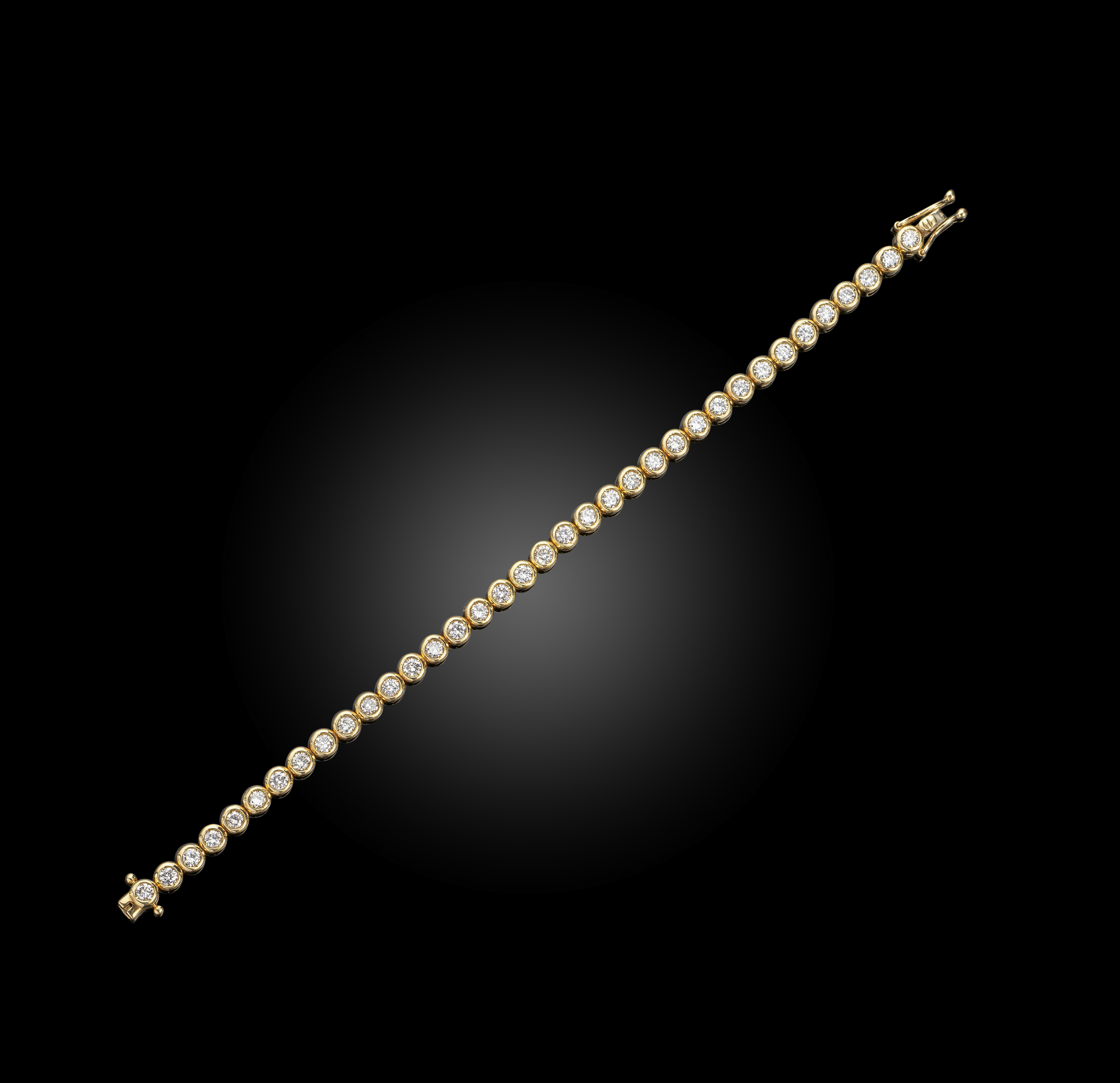 A diamond line bracelet, set with round brilliant-cut diamonds rubover-set in 18ct yellow gold,