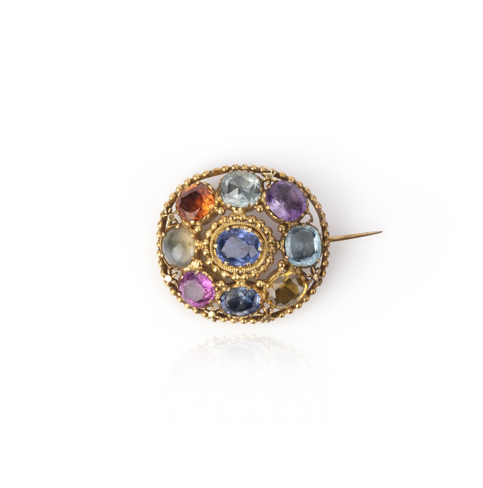 A mid 19th century nine stone brooch, the oval brooch set with sapphire, catseye, garnet, topaz