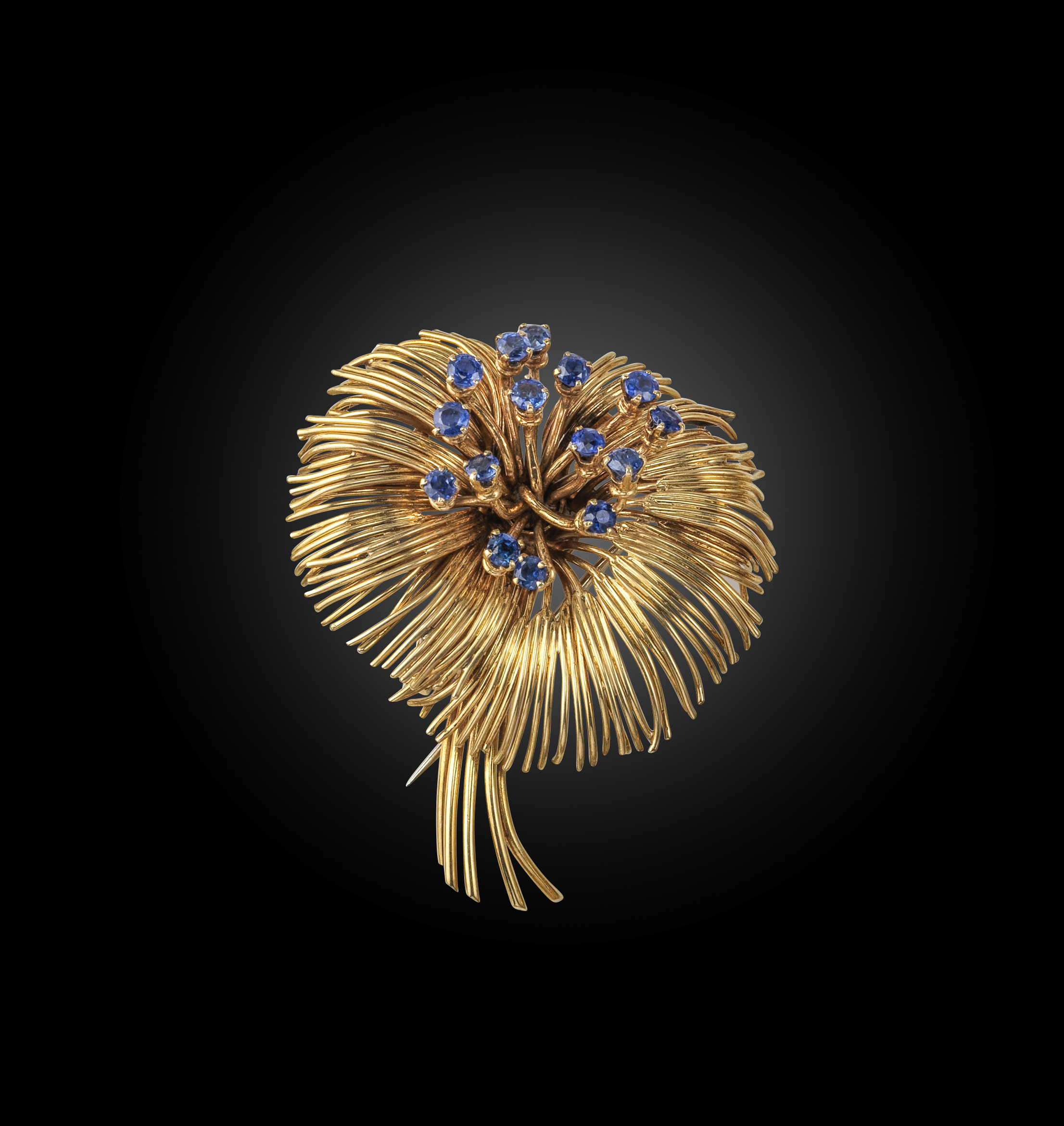 Van Cleef & Arpels, a sapphire spray brooch, C1950, set with a cluster of circular-cut sapphires