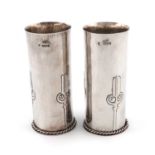 By Hugh Wallis, a pair of Arts and Crafts silver vases,Chester 1926,plain circular form, embossed