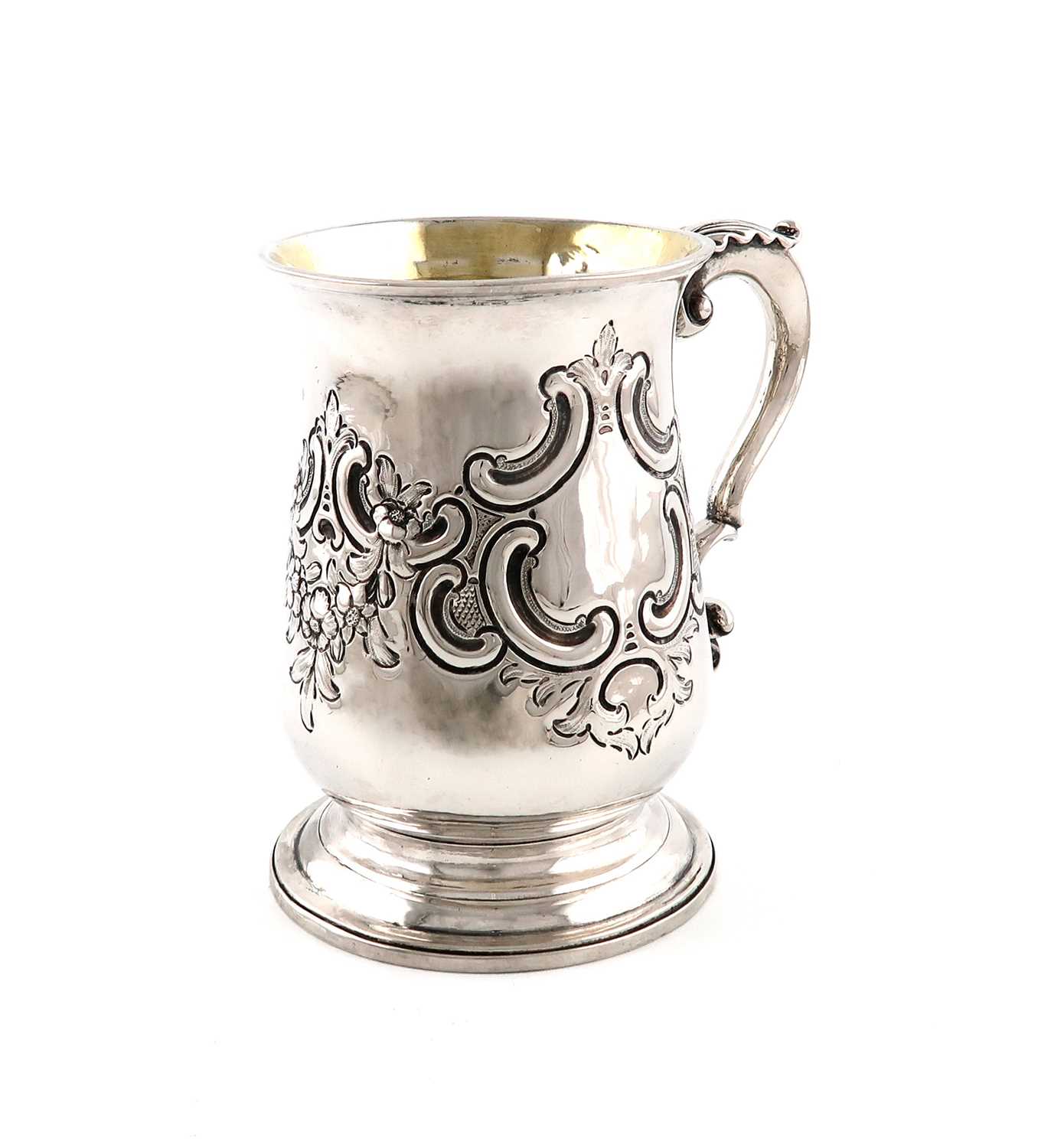 A George III silver mug,by James Sutton, London 1781,baluster form, leaf-capped later foliate scroll