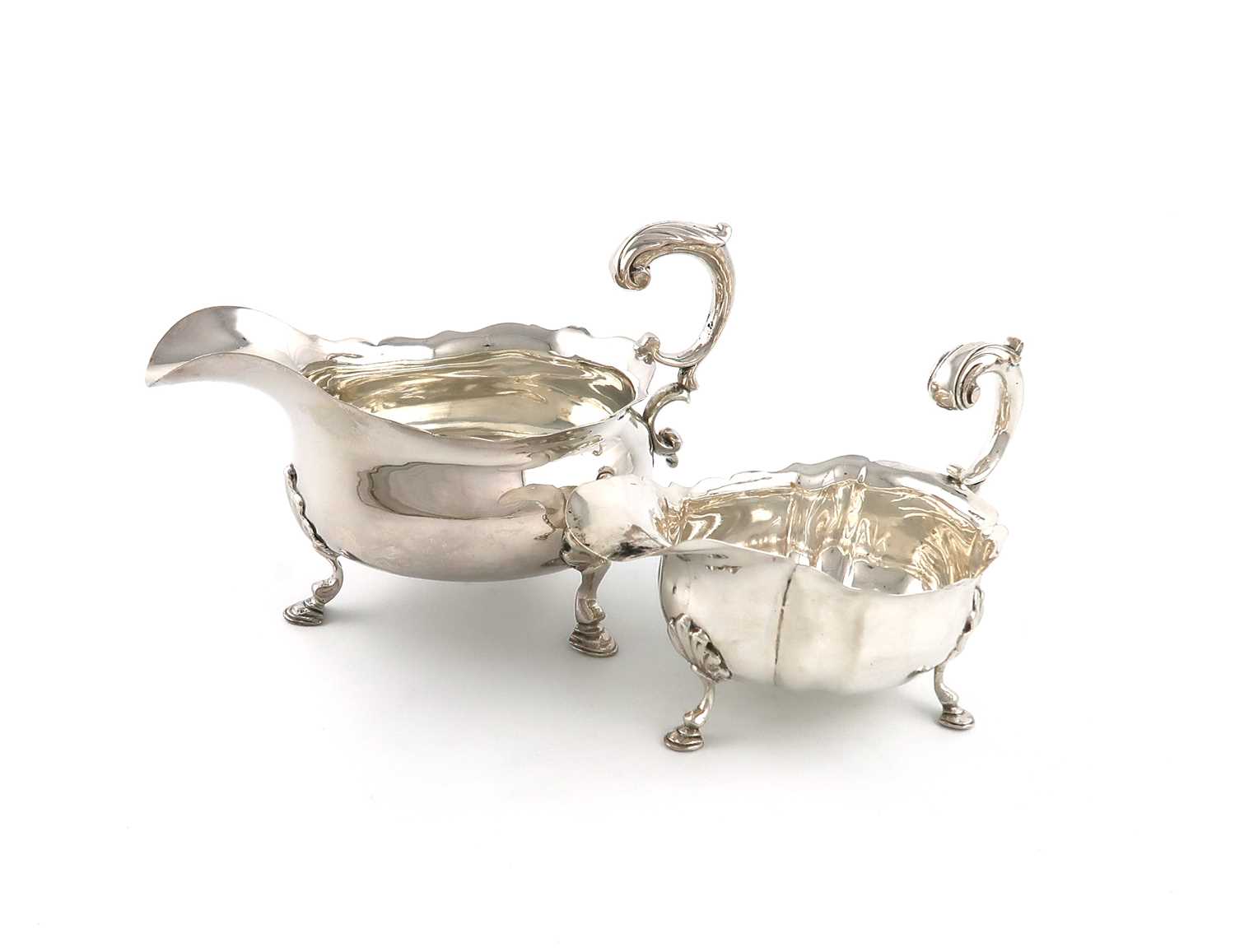 A George II silver sauce boat,marks worn, probably 1746 or 1753, oval form, wavy-edge border, leaf