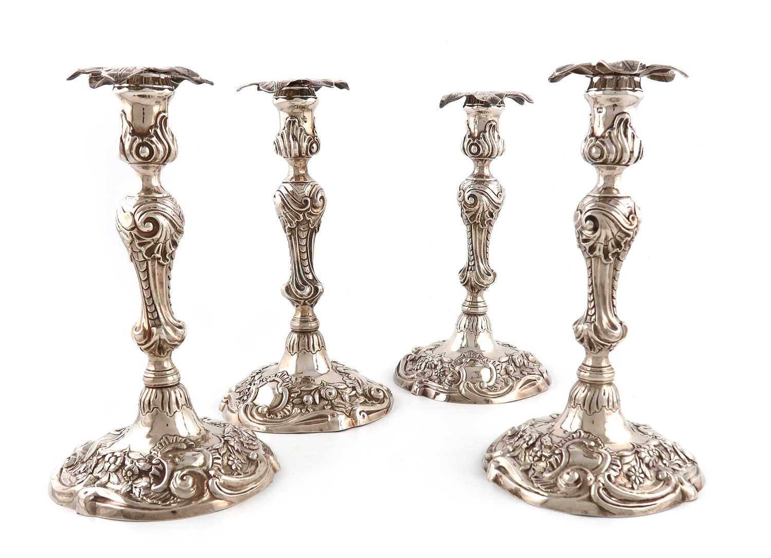 A set of four George II silver candlesticks,by William Cafe, London 1758,baluster stems with shell