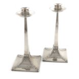 A pair of Arts and Crafts silver candlesticks,by James Dixon and Sons, Sheffield 1916,tapering