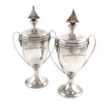 A pair of silver yachting trophy cups, by Edward Dimes, London 1935, vase form, plain scroll