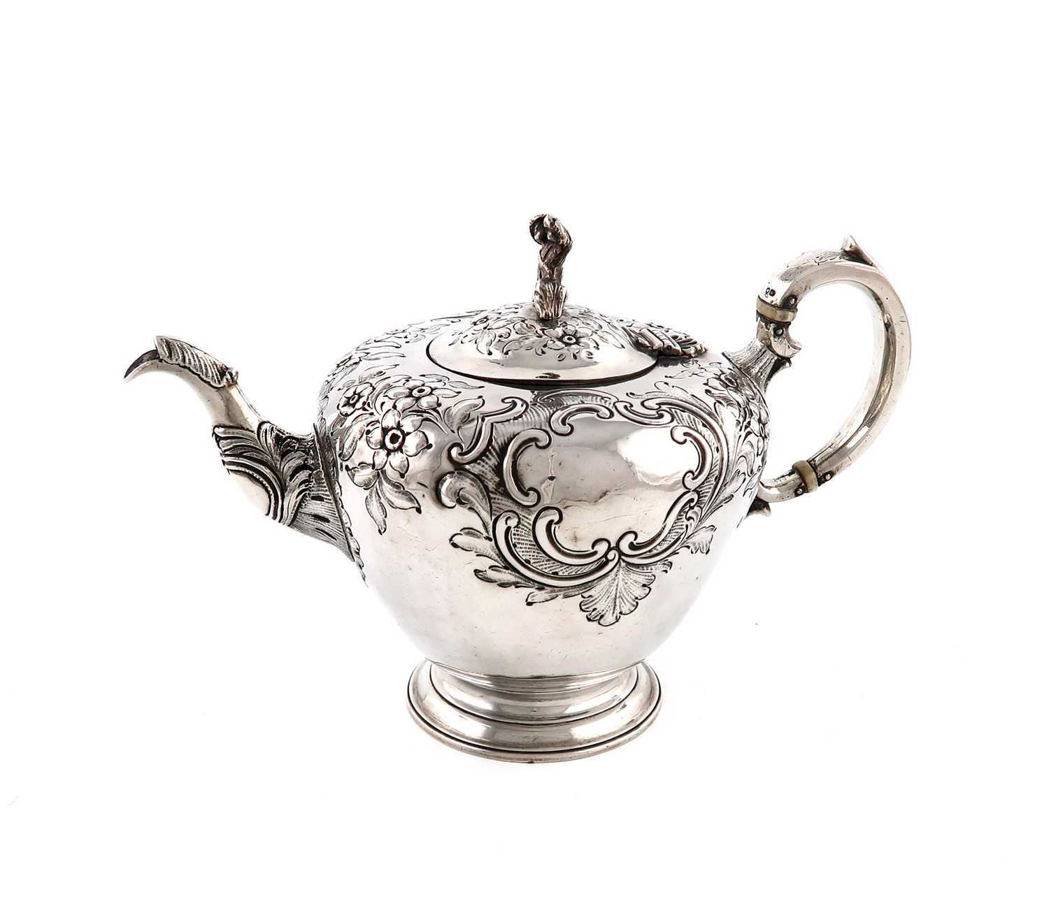λ λA Victorian silver teapot,by William Moulson, London 1845,circular form, embossed foliate