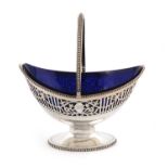 A George III silver swing-handled sugar basket,by William Plummer, London 1784,oval form, pierced