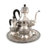 A three-piece Malaysian metalware coffee set and tray,Kelantan,baluster form, foliate decoration,