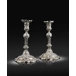 A pair of George II cast silver Rococo candlesticks,by Ayme Videau, London 1743,baluster columns,