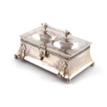 By A. E. Jones, an Edwardian Arts and Crafts silver double inkwell,Birmingham 1907,casket form,