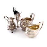 A small collection of four George II and George III silver cream jugs, comprising: one of baluster