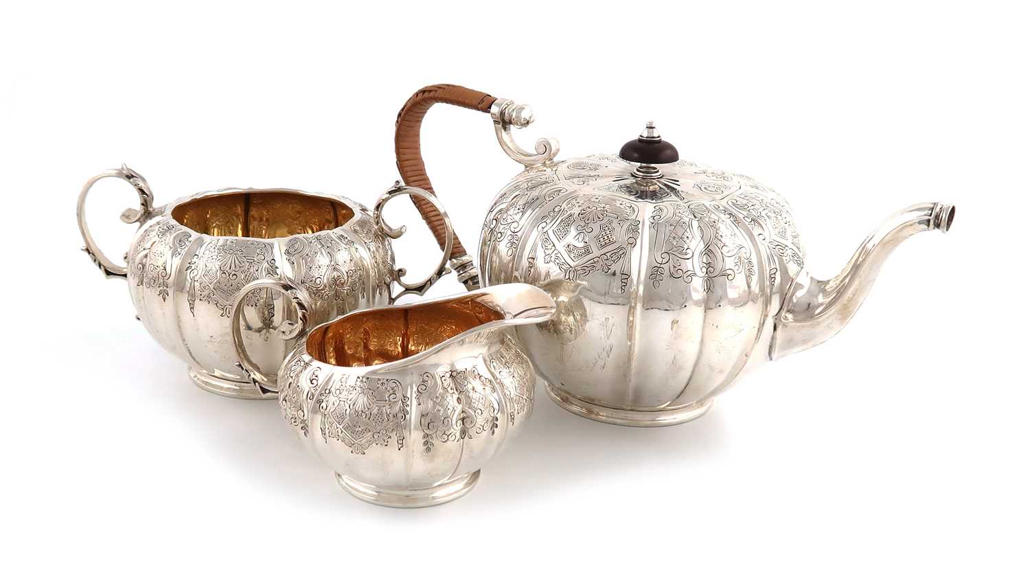 A three-piece silver tea set,by Elkington and Co., Birmingham 1946,lobed circular form, engraved