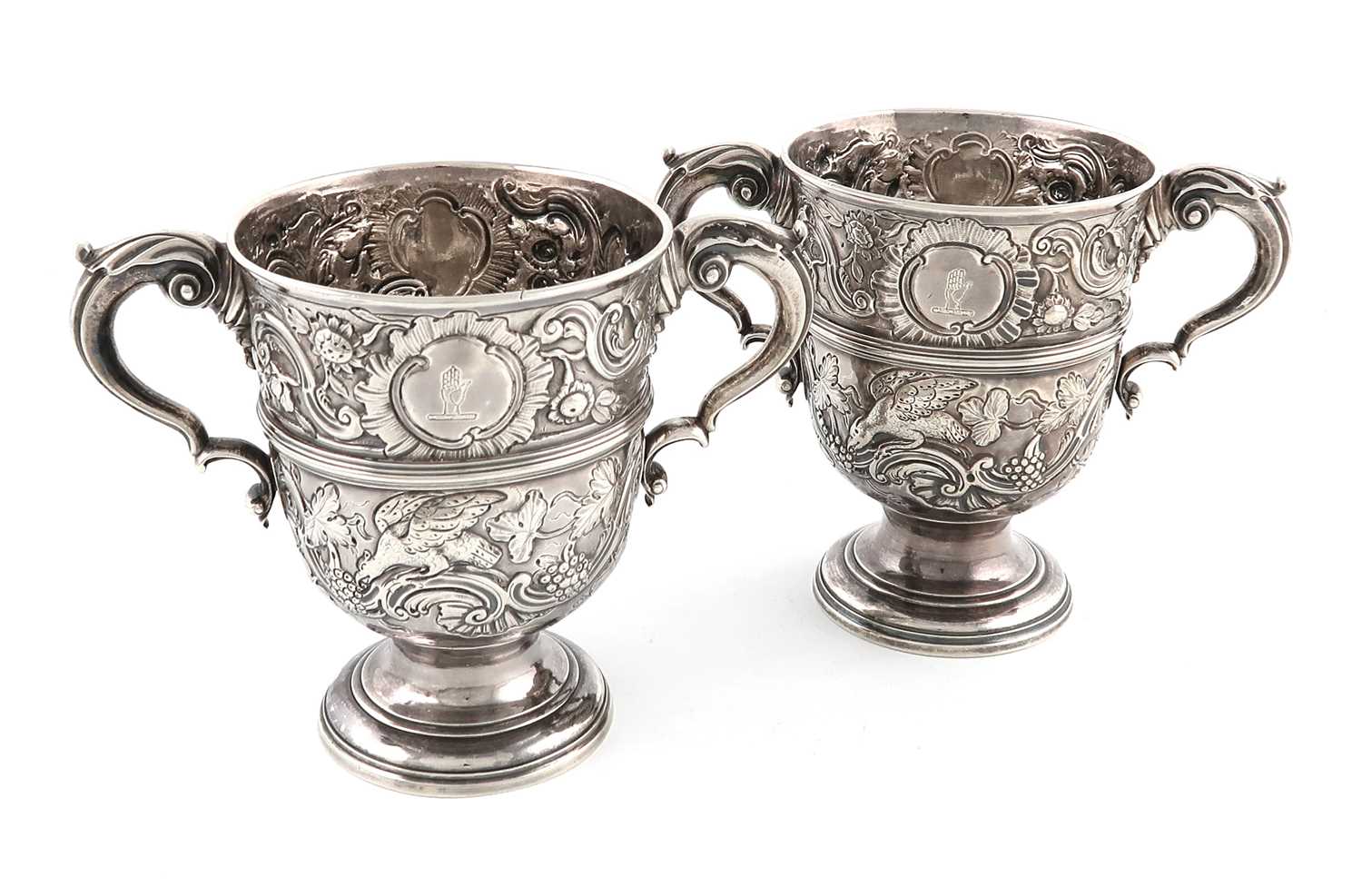 A pair of mid-18th century Irish silver two-handled cups,marks partially lost in decoration,