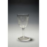 A large Jacobite wine glass or goblet, c.1760, the generous round funnel bowl engraved with a rose