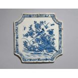 A Delft plaque, 18th century, of square form with chamfered corners, painted with long-tailed