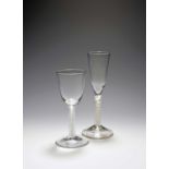 A large wine glass and an ale glass, c.1750-60, the wine glass with a round funnel bowl over a mixed