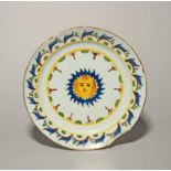 A rare delftware plate, c.1760-70, probably Bristol, painted in blue, green, red and yellow with a