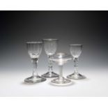 Three small wine glasses, c.1760-70, with ogee bowls cut to the base and raised on faceted stems