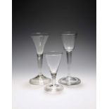 Three small wine glasses, c.1740-50, two with drawn trumpet bowls over plain stems, the larger