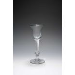 A composite stem wine glass, c.1750, the bell bowl raised on an airtwist stem above a flattened