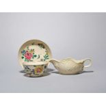 A Staffordshire salt-glazed teabowl and saucer, c.1760, brightly painted with flower sprays, and a