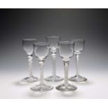 Five small wine glasses, c.1760-70, four with ogee bowls, one with an ovoid bowl, all on varying