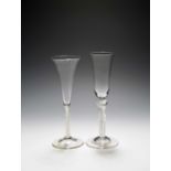 An ale glass and a wine flute, c.1750-60, the ale with an elongated funnel bowl raised on a double-