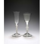 A large wine glass and an ale glass, c.1760-70, the wine with a round funnel bowl over a knopped