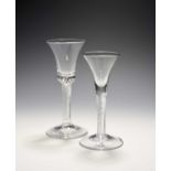 Two wine glasses, c.1750, one with a bell bowl, the other a drawn trumpet bowl, each raised on a